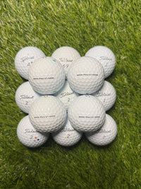 A/pearl grade Titleist Pro V1 golf balls arranged on the fairway