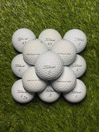 Close view of A/pearl grade Titleist Pro V1 golf balls on grass