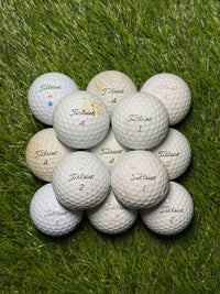 C-grade Titleist Pro V1 golf balls showing play wear
