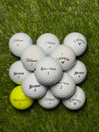 Premium brand golf ball mix in A grade stacked on grass