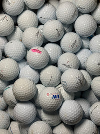 Graded white Titleist golf balls sorted in a tray