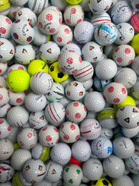 Mixed premium A-grade golf balls in white and yellow, sorted for grading