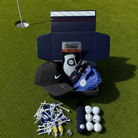 Captains golf mystery box on grass with a Nike cap, glove, golf balls and tees